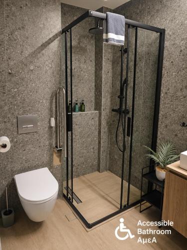 a shower stall in a bathroom with a toilet at 8 Blocks Apartments - Alexandroupoli in Alexandroupoli