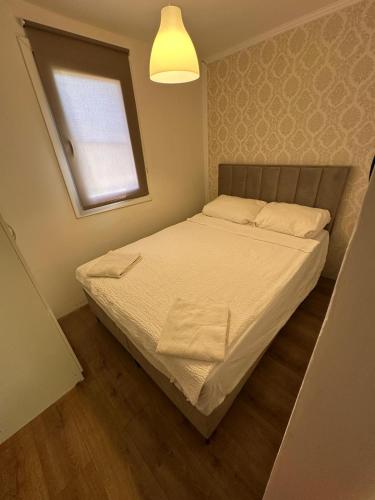 a small bedroom with a bed with a window at Rustic in Vir