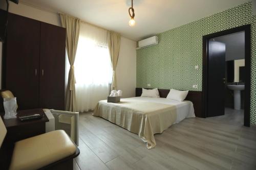a bedroom with a bed and a window and a sink at Casa Izabela in Năvodari