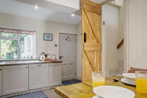 a kitchen with a wooden door and a table at 2 Bed in Cherry Burton oc-c37535 in Cherry Burton