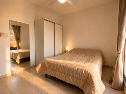 a bedroom with two beds and a cabinet in it at Destino Wilde in Resistencia