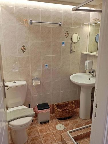 a bathroom with a toilet and a sink at Blue Sea Suite Avlakia in Avlákia