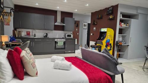 a living room with a bed and a kitchen at Victoria Loft - 1 Bedroom Apartment with off site spa access in Bowness-on-Windermere