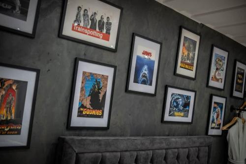 a wall with a bunch of movie posters on it at Victoria Loft - 1 Bedroom Apartment with off site spa access in Bowness-on-Windermere