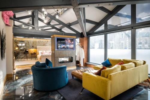 a living room with two couches and a fireplace at Architect's Loft in Windermere