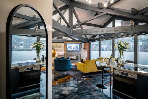 a kitchen and living room with a yellow couch at Architect's Loft in Windermere