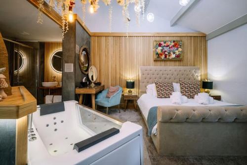 a bedroom with a bed and a bath tub at Queen's Loft in Windermere
