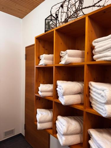 a room with a wooden shelf filled with towels at Residenz Dunza Hotel Garni in Bürserberg