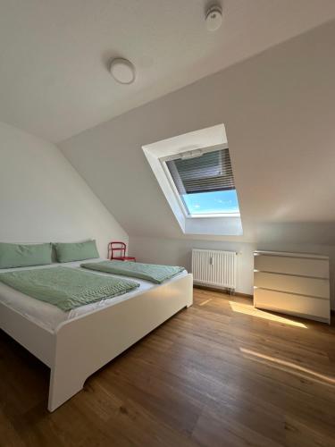 a bedroom with a bed and a skylight at SWISS LOFT by Europa-Park - EP Ticket Garantie in Rust