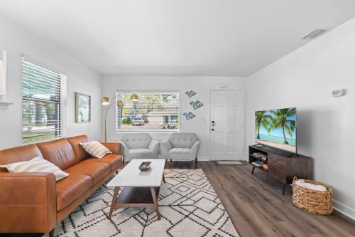 a living room with a couch and a tv at Teal We Meet Again - Team Joseph Ellen in Jacksonville Beach