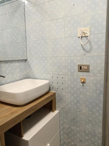 a bathroom with a white sink on a counter at Casa Cavour 15 in Porto Santo Stefano