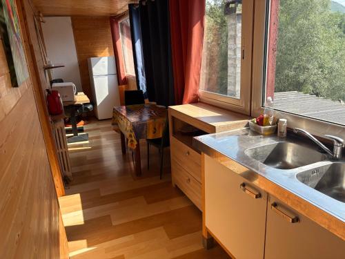 a kitchen with a sink and a counter top at La Cheminée - Chambres Gîtes Appartements et Mobile Homes avec Bar-Restaurant in Tardets-Sorholus