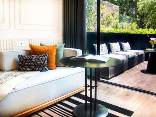 a living room with a couch and a table at Oliver Mexico City in Mexico City