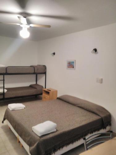 a bedroom with two bunk beds in a room at Complejo Brisas Místicas in Las Grutas