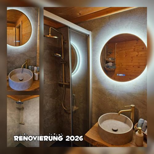 a bathroom with two sinks and a shower with a mirror at Chalet Bergliebe Turrach in Turracher Hohe