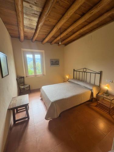 a bedroom with a large bed and a window at Finca El Cerro in Ronda