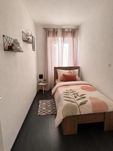 a bedroom with a large bed in front of a window at Lalya App in Vodnjan