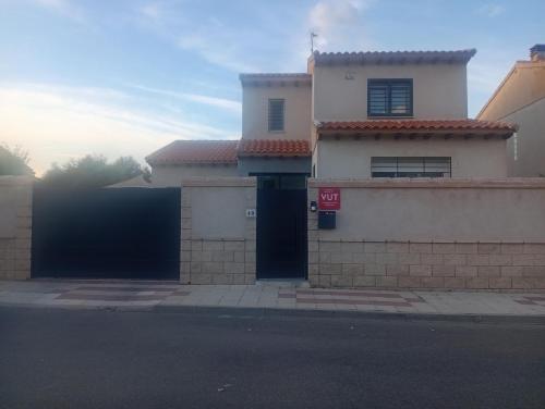 a house with two garage doors on a street at Casa Puerta de Toledo, a 8 minutos de Puy du Fou in Cobisa