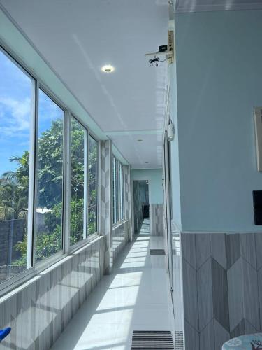 a hallway of an office building with windows at Ege Inn in Guraidhoo