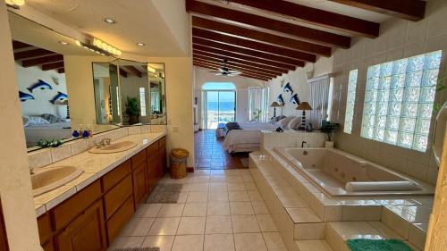 a large bathroom with two sinks and a tub at Baja Del Mar 47 in Rosarito Beach