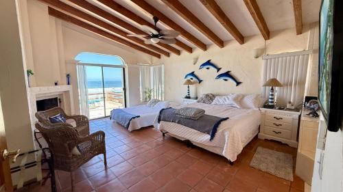 a bedroom with two beds and a fireplace at Baja Del Mar 47 in Rosarito Beach