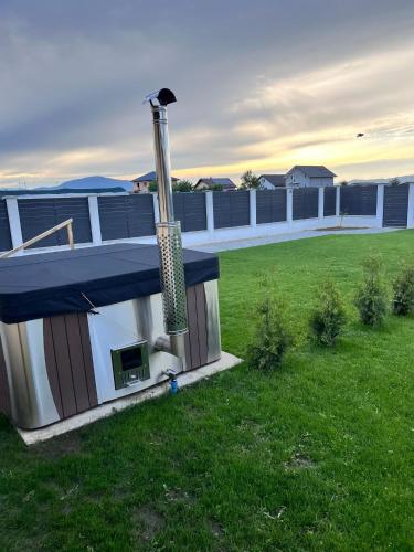 a dog house with a heater on top of a yard at Casa Bella in Sînpetru