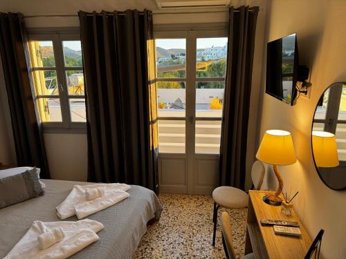 a hotel room with a bed and a window at Naousa Nest in Naousa