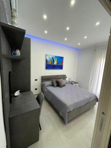 a bedroom with a bed and a chair in it at Le Perle di Aspra in Aspra
