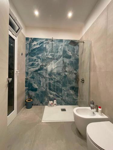 a bathroom with a shower and a toilet and a sink at Le Perle di Aspra in Aspra