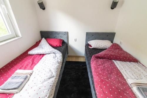 two beds sitting next to each other in a room at Guest House Lejla in Travnik