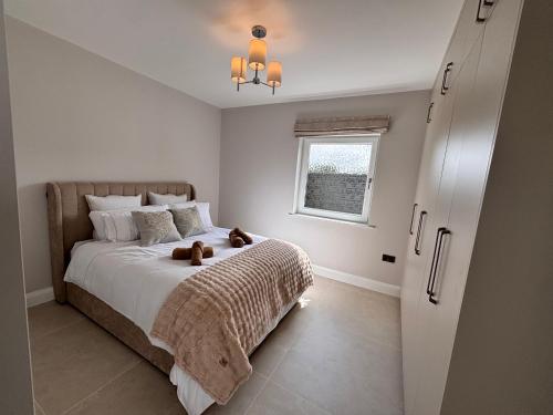 a bedroom with a bed with two teddy bears on it at Luxury sea view villa in Ballycastle