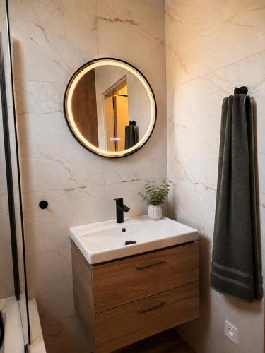 a bathroom with a sink and a mirror at Apartmán u Fary-Harmony in Adršpach
