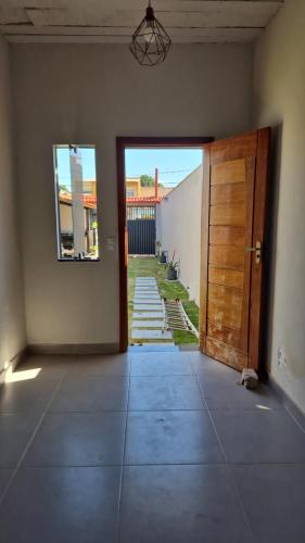 an empty room with a door and a hallway at Casa Real in Guarapari