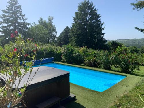 a swimming pool in the garden of a house at Suite-piscine et jacuzzi sous les étoiles - petit déjeuner inclus ou non, et repas froid en option in Septème