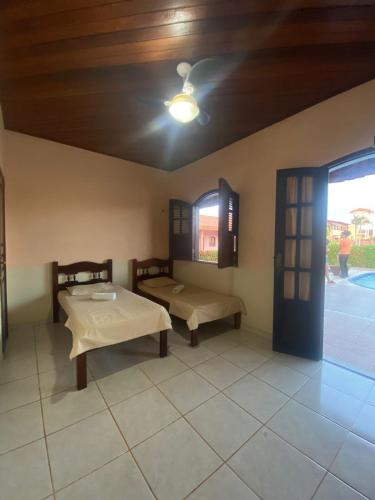 a room with a table and a bench and a door at Pousada Caranã in Salinópolis