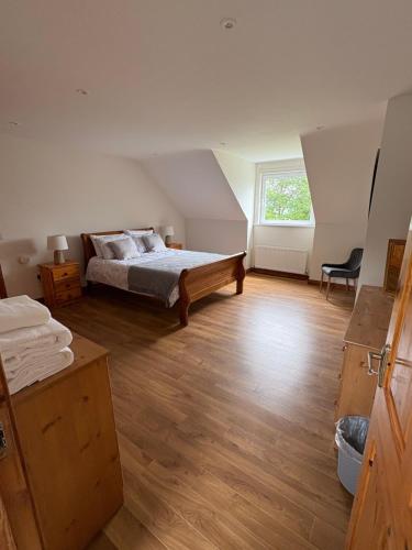 a large bedroom with a bed and a window at Kilmurry heights in Kenmare