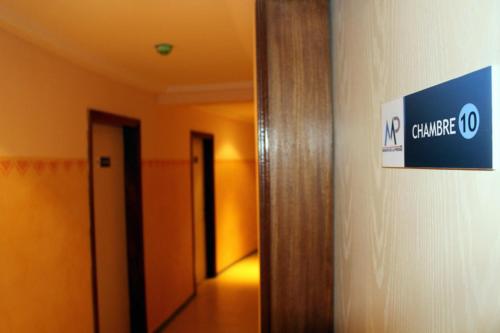 a hallway of an office with a sign on the wall at Maison Babacar TOURE in Dakar