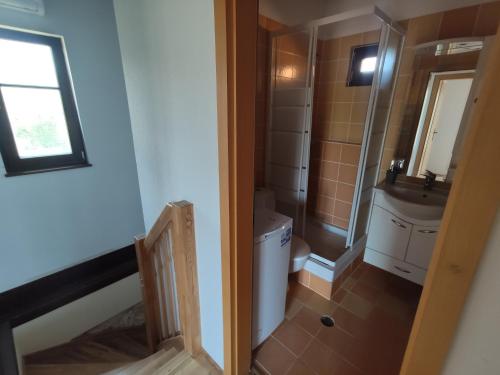 a bathroom with a toilet and a sink at Villas garden&pool in Afitos