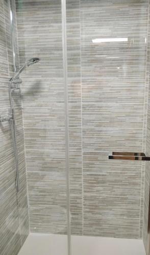 a shower with a glass door in a bathroom at Le Giunchete in Cavriglia