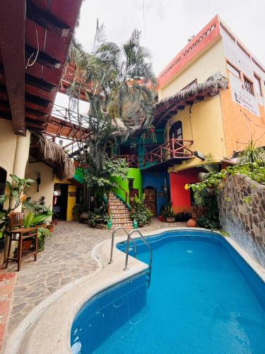 a hotel with a swimming pool in front of a building at Hotel Artesanal Palomera in San Francisco