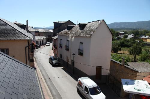 a car parked on a street in a town at La Casina del Pozo in Bembibre