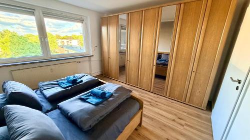 a room with a couch and a large window at Apartment Hannover - Langenhagen center in Hannover