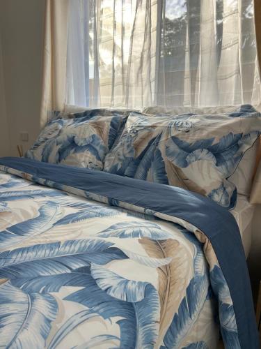 an unmade bed in a bedroom with a window at Hildas Villa in Arorangi