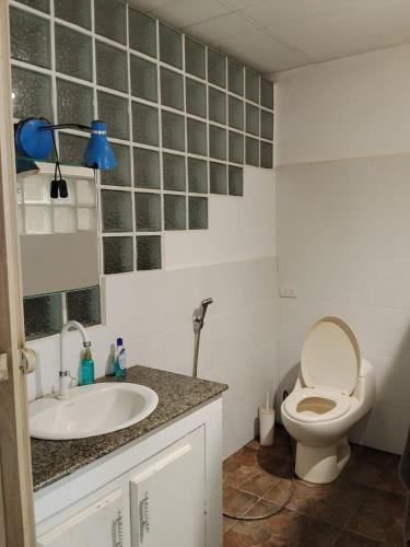 a bathroom with a toilet and a sink at PlayaMariaChiquita in Colón