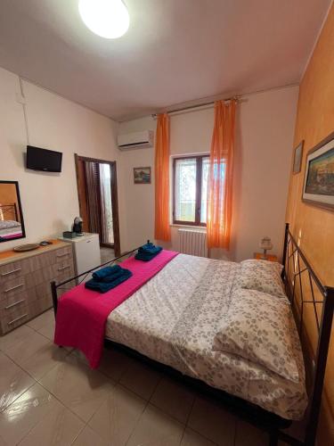 a bedroom with a large bed with a red blanket at Dream Beach Salento in Porto Cesareo