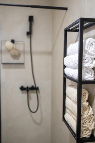 a bathroom with a towel rack with a shower at Modern Studio Apartment in Žepče