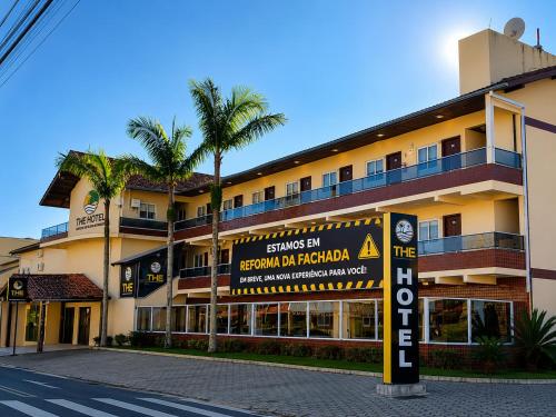 a large building with a sign in front of it at THE - Tropicanas Hotel e Eventos in Florianópolis