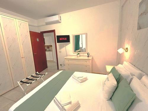 a bedroom with a bed and a sink in it at Port Haven Suite Civitavecchia in Civitavecchia