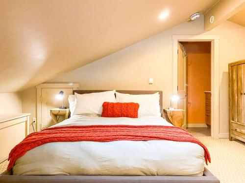 a bedroom with a large bed with a red pillow at Slopeside Chalet in Steamboat Springs