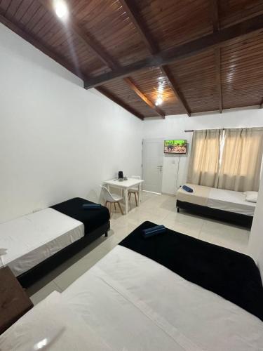 a bedroom with two beds and a table in it at Aguara Falls in Puerto Iguazú
